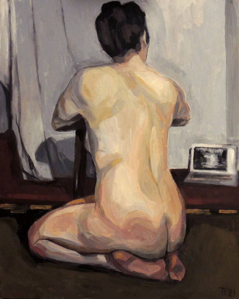 Donna nuda con un portatile da Tore Bahnson