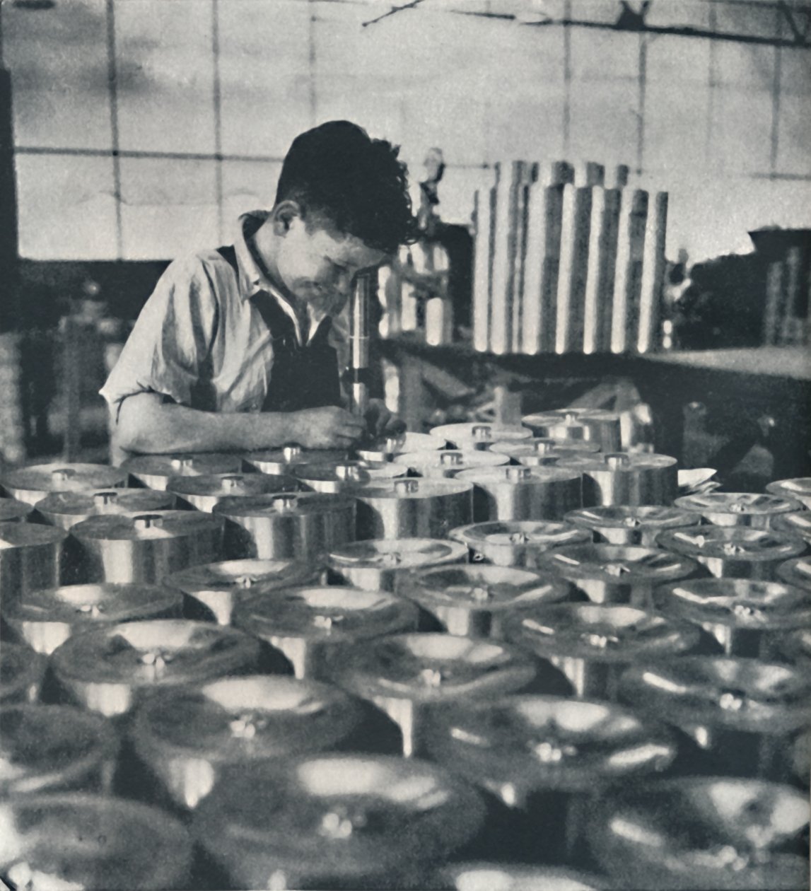 Apprendista con microscopio che testa la durezza dei pistoni, 1941 da Cecil Beaton