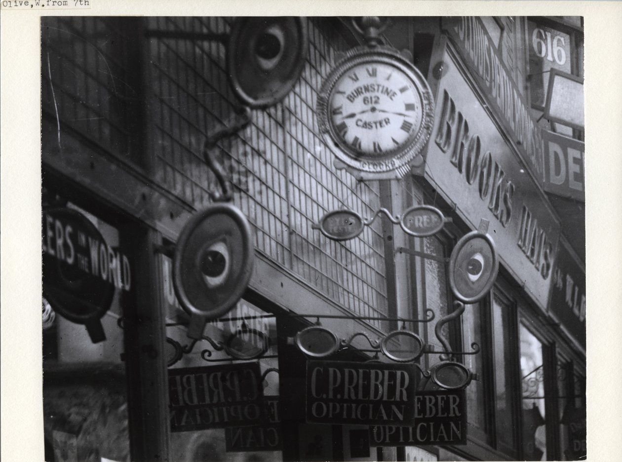 Insegne per C.P. Reber Ottico, Burnstine Caster Clocks e Brooks Hats lungo le loro vetrine al 612-614 Olive Street da Charles Clement Holt