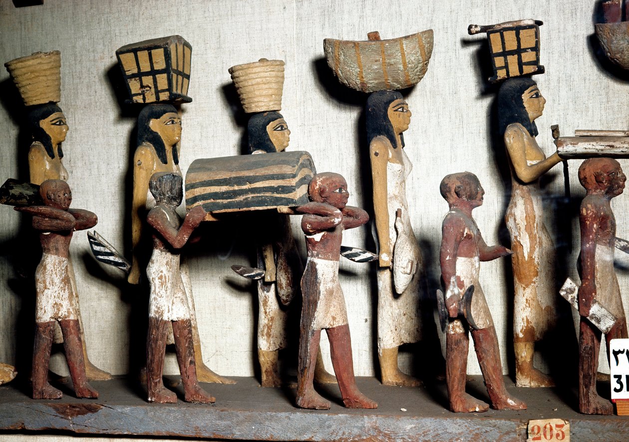 Antichità egizia: un gruppo scolpito in legno dipinto che rappresenta servi che portano offerte al defunto. Il Cairo, Museo Egizio da Egyptian Egyptian