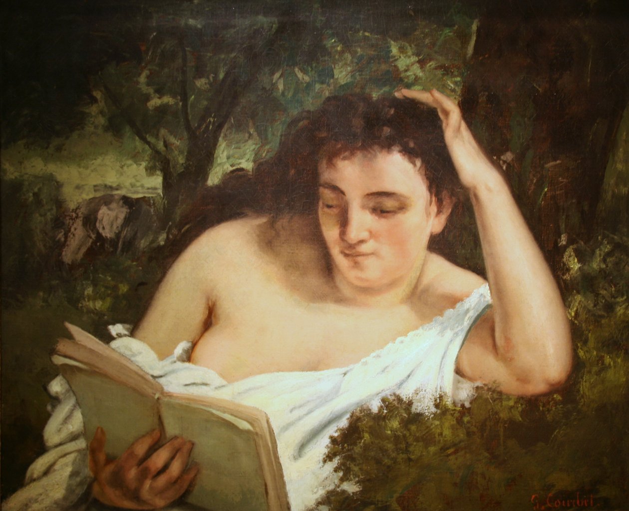 Una giovane donna che legge da Gustave Courbet
