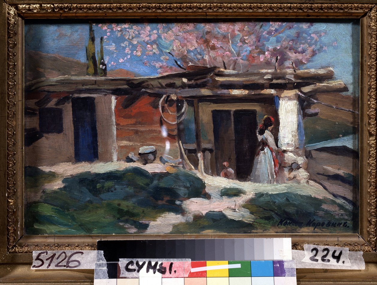 Crimea, i mandorli in fiore. Giovane donna davanti a una piccola casa di legno, sotto i mandorli rosa da Konstantin Alekseevich Korovin