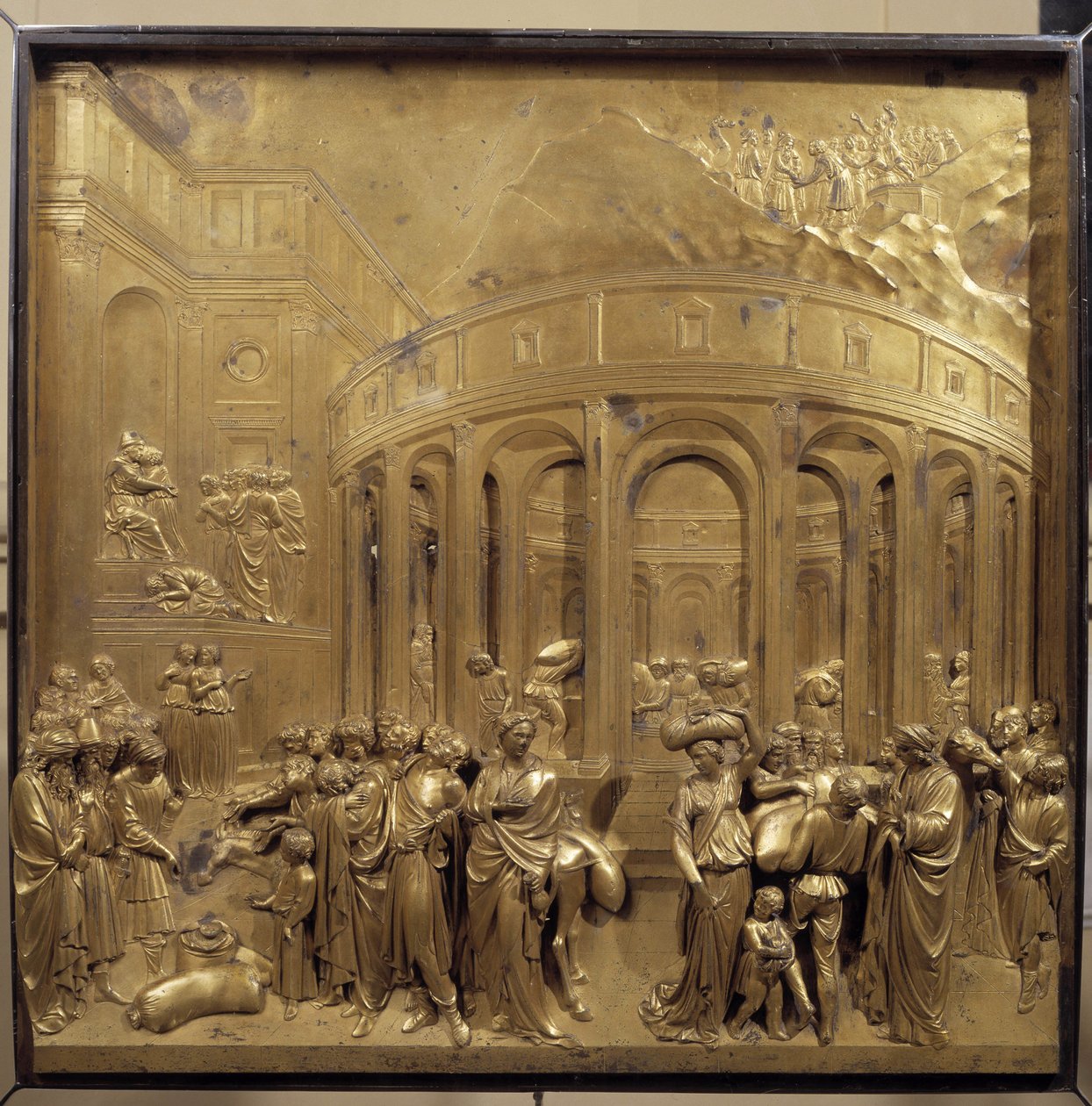 Storia della vita di Giuseppe. La raccolta del grano: i contadini portano i sacchi di cereali. Pannello originale della porta del Paradiso da Lorenzo Ghiberti