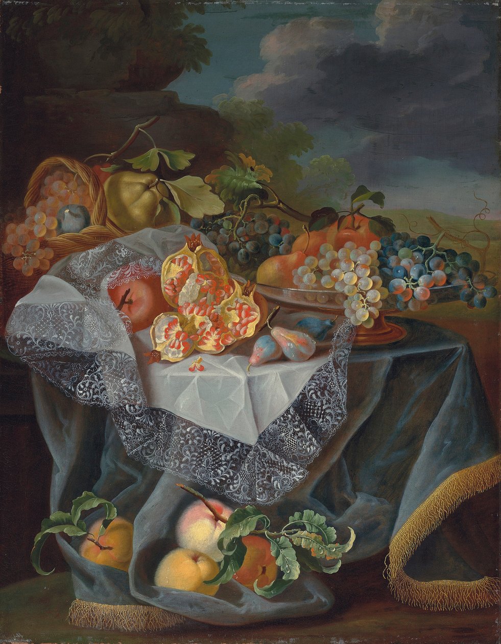 Uva, pere e una mela su un vaso di vetro, melograni e un cesto intrecciato con frutta su un tavolo drappeggiato, e un paesaggio di parco oltre da Maximilian Pfeiler or Pfeiller