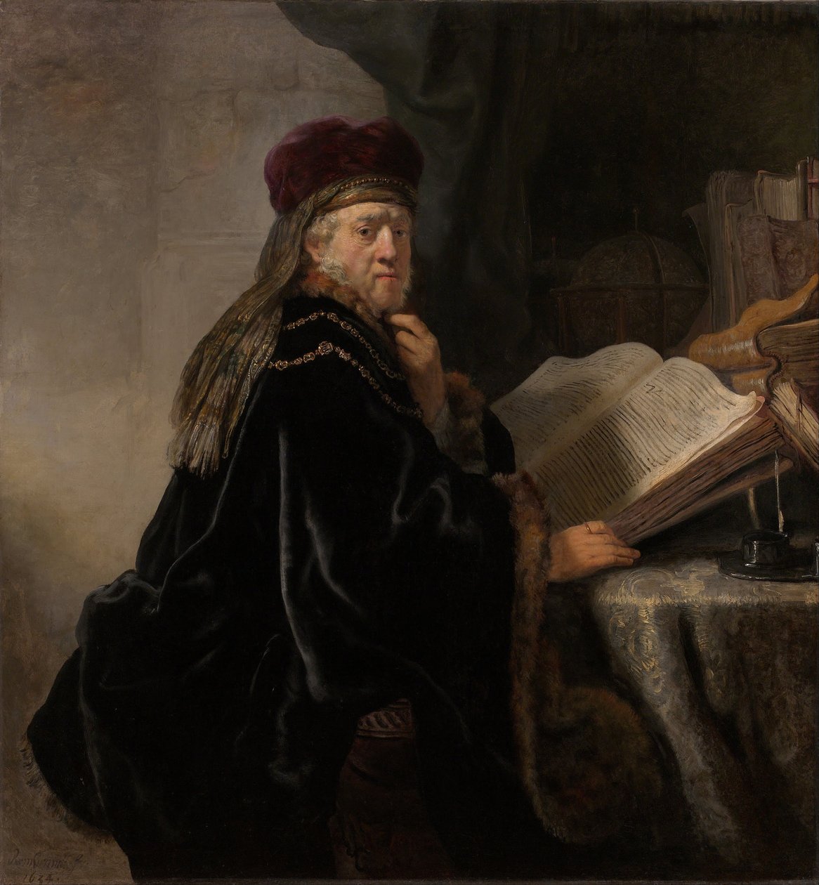 Uno studioso seduto a una scrivania da Rembrandt van Rijn