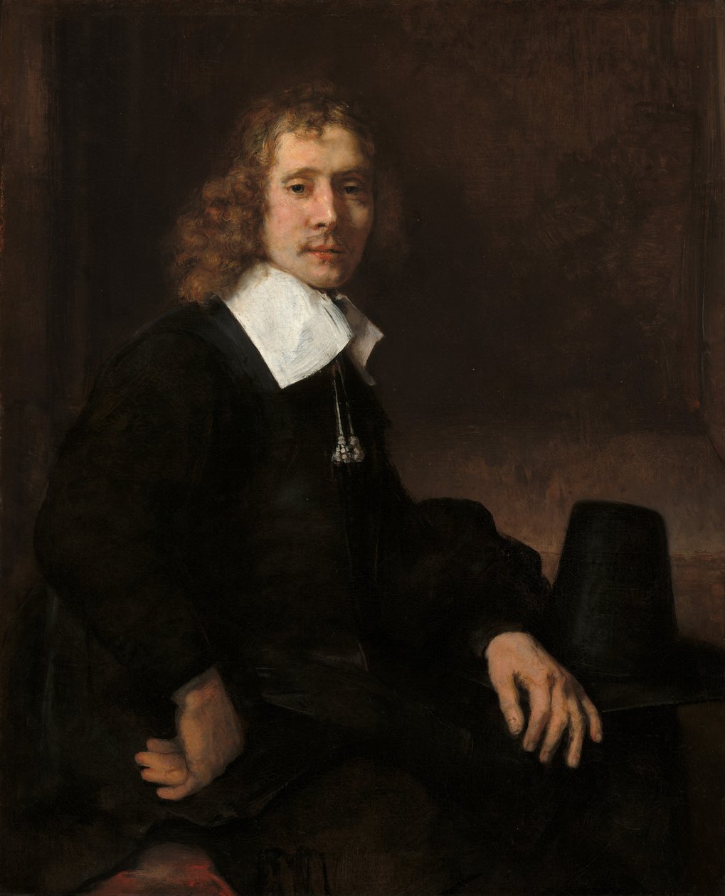 Un giovane seduto a un tavolo, possibilmente Govaert Flinck da Rembrandt van Rijn