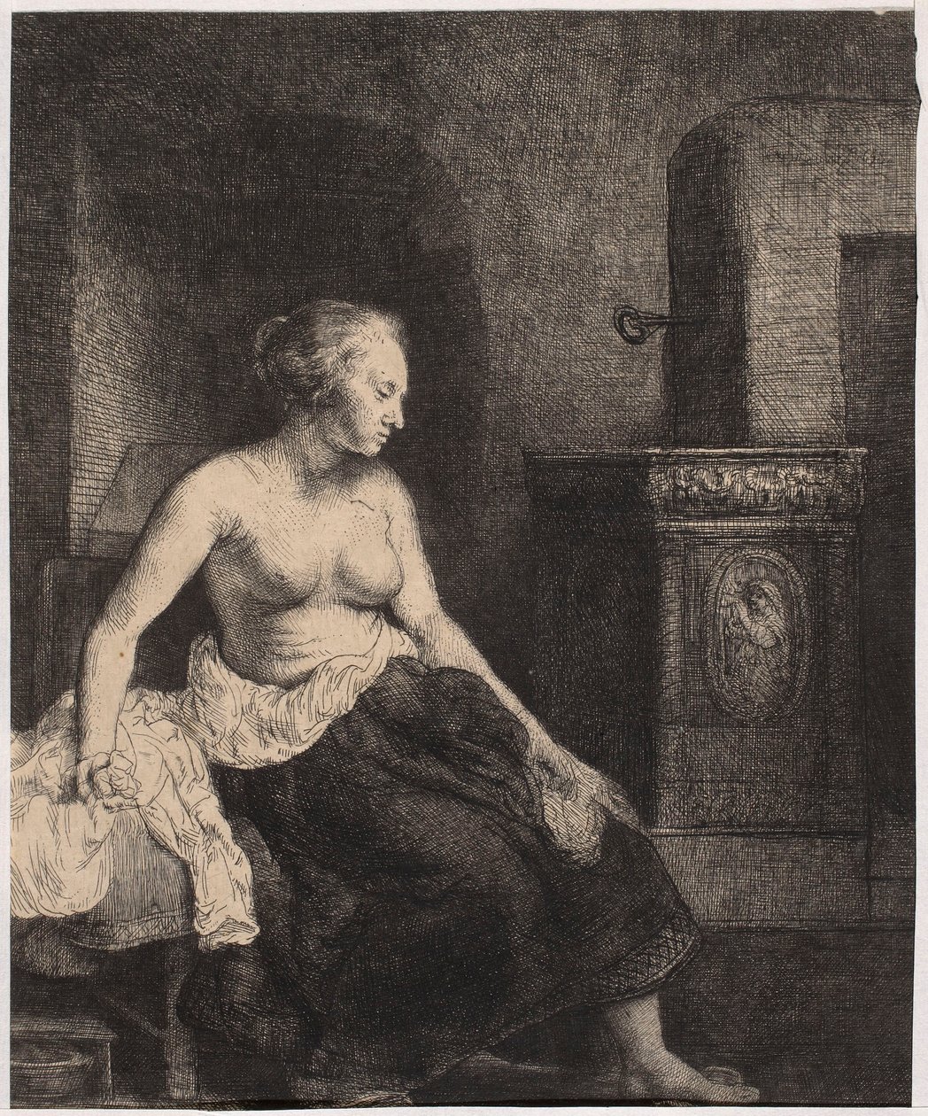 Una donna seminuda seduta accanto alla stufa da Rembrandt van Rijn