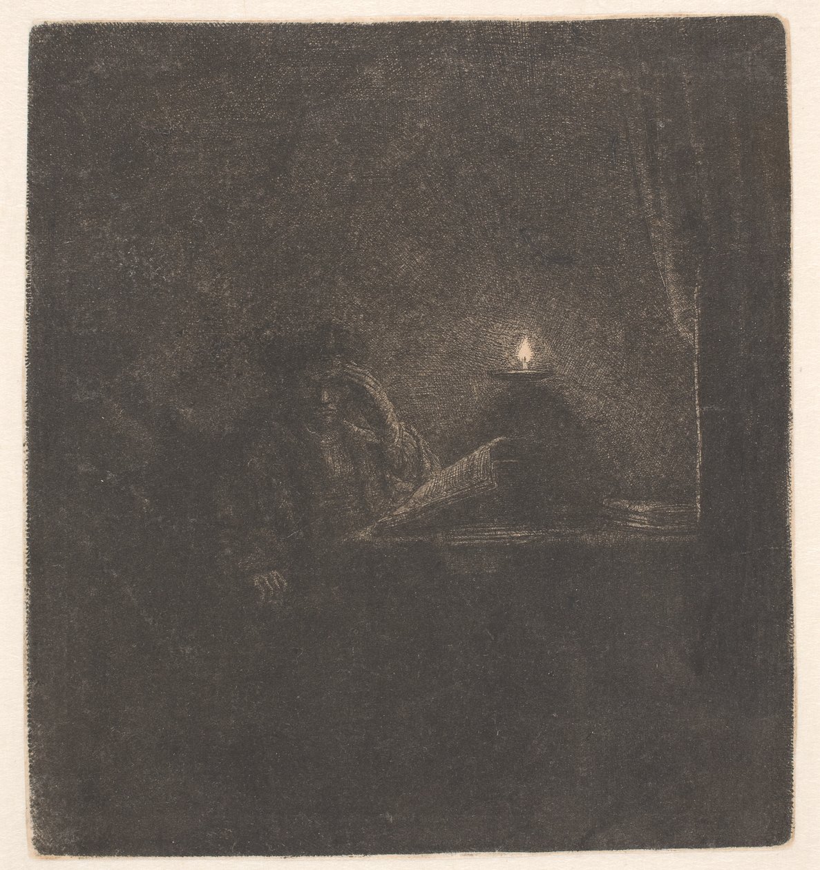 Uno studente seduto a un tavolo alla luce di una candela da Rembrandt van Rijn