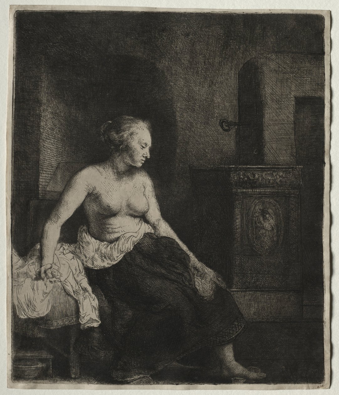 Donna seduta mezza vestita accanto a una stufa, 1658 da Rembrandt van Rijn