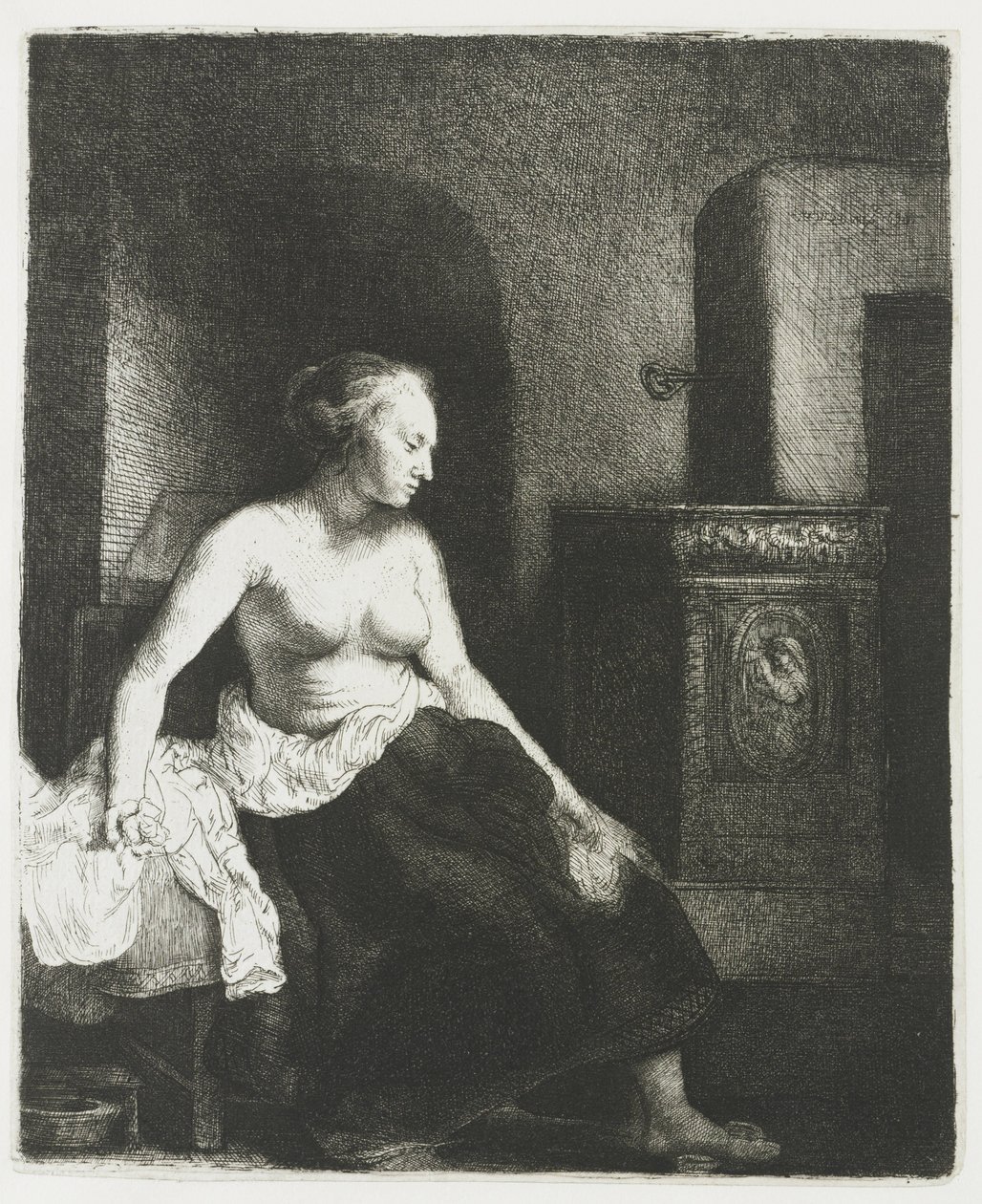 Donna seduta mezza vestita accanto a una stufa da Rembrandt van Rijn
