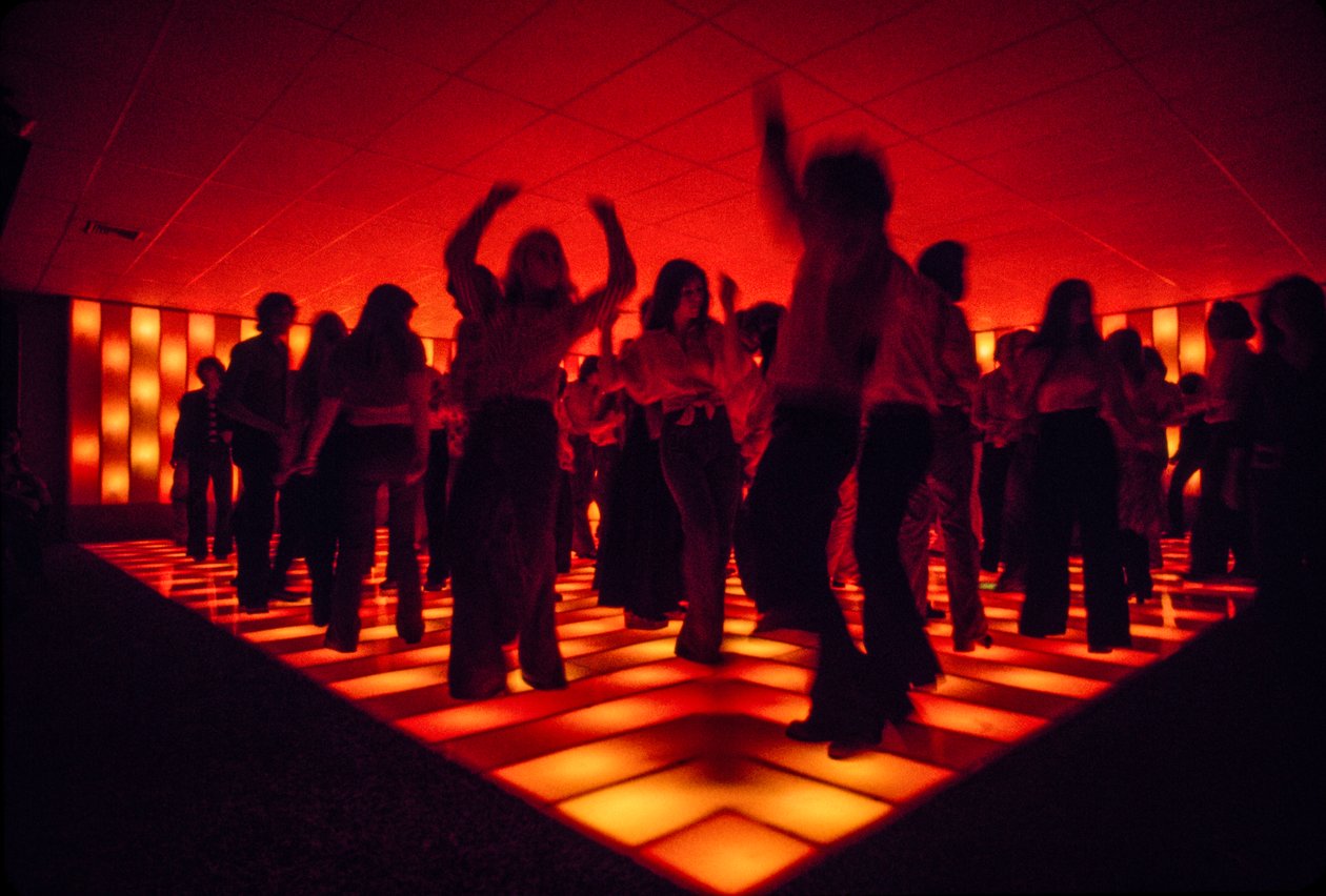 Giovani ballerini in una discoteca che ballano su un pavimento illuminato da Ted Spiegel
