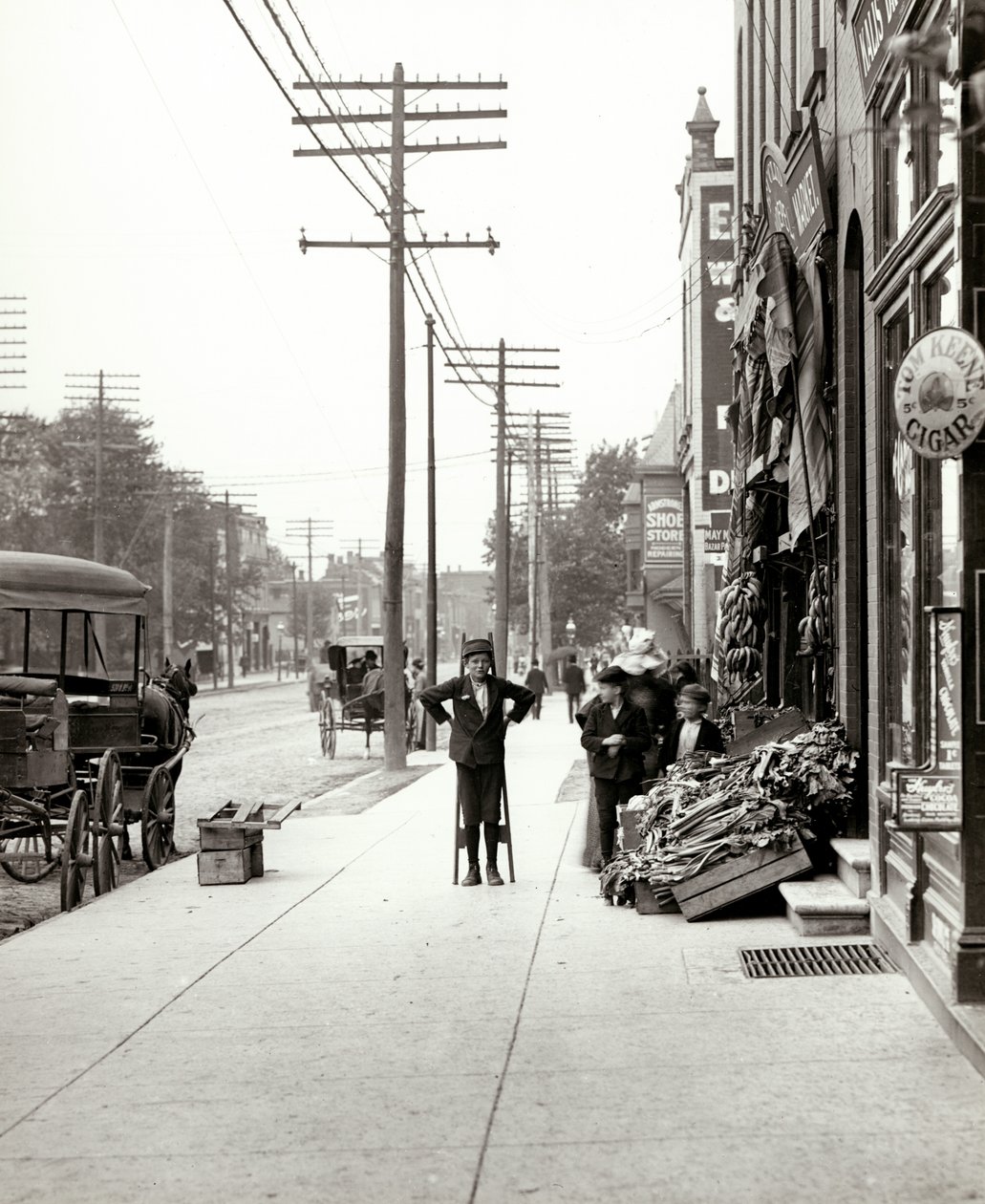 Un ragazzo con trampoli davanti al mercato F.J. Voepel al 4874 Easton Avenue, all