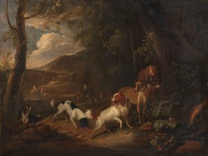 Cacciatore con cani ai margini di un bosco
