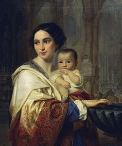 Madre con bambino in braccio che attinge l’acqua benedetta