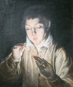 Ragazzo che soffia su un tizzone