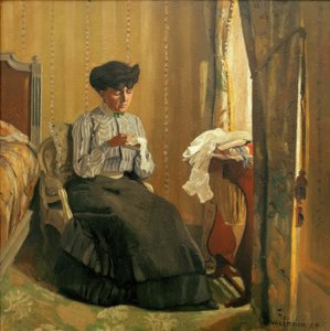 Giovane donna che cuce vicino alla finestra