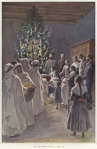 Un gruppo familiare che guarda una scena della natività vicino a un albero di Natale