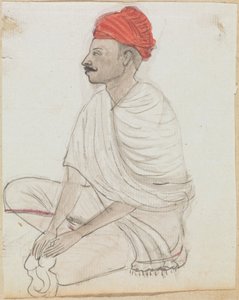 Uomo con turbante rosso seduto a gambe incrociate