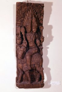 Agni, dio del fuoco, raffigurato con due teste (bicefalo) su un ariete, secondo la mitologia indù. Scultura in legno del XVII secolo. Parigi, Musée Guimet. da Indian School