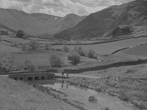 Una veduta attraverso un ponte, un ruscello, campi e colline da Joseph Hardman