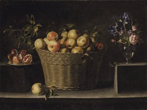 Mele in un cesto di vimini, un melograno su un piatto d