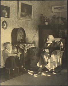 [Uomo e ragazzo seduti in uno studio]