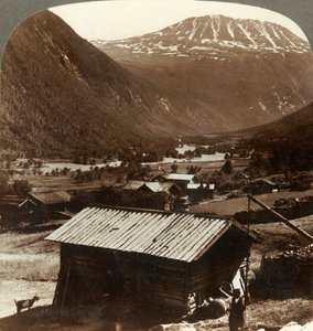 Altezze innevate del Monte Gausta sopra le tranquille case nella Valle di Maan, Norvegia