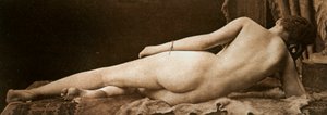 Giovane donna nuda vista da dietro, sdraiata su una pelle di animale