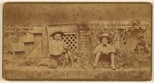 [Due ragazzi seduti a terra con un cane] da Unknown artist