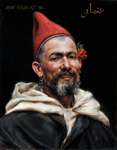 Ritratto di uomo marocchino con orecchini e cappello rosso, con un fiore nell