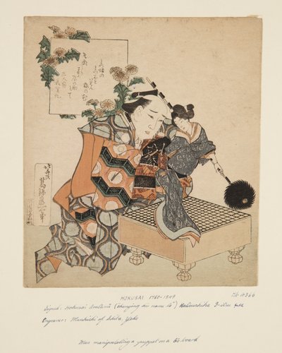 Burattinaio che tiene un burattino su una tavola da go (stampa xilografica a colori) da Katsushika Hokusai