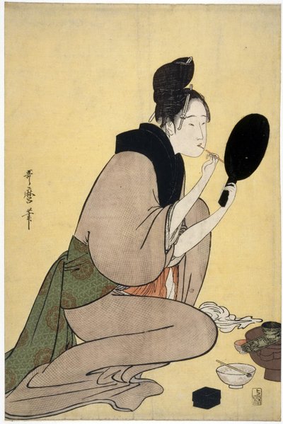 Sulla bellezza: donna che si trucca le labbra da Kitagawa Utamaro