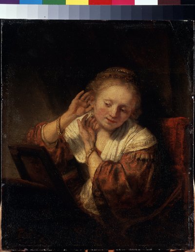 Giovane donna che prova gli orecchini da Rembrandt Harmensz. van Rijn