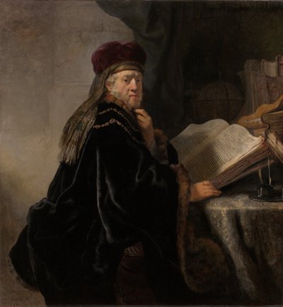 Uno studioso seduto a una scrivania da Rembrandt van Rijn