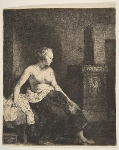 Donna seduta mezza vestita accanto a una stufa da Rembrandt van Rijn