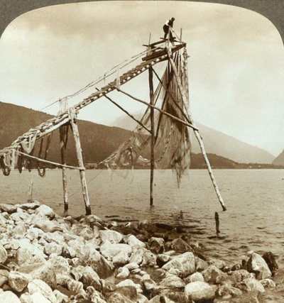 Pescatore che sistema le reti per il salmone a Balestrand sul Sognefjord - Balholm in lontananza, Norvegia, c1905 da Unbekannt