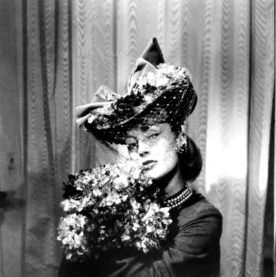 Donna con cappello con velo, che tiene un mazzo di fiori, Parigi, 1943 da Unbekannt