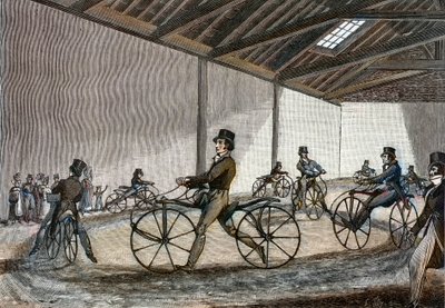 Vista interna del maneggio per cavalli a dondolo. Uomo che guida biciclette (biciclette senza pedali inventate dal barone Karl Drais) da Unknown artist