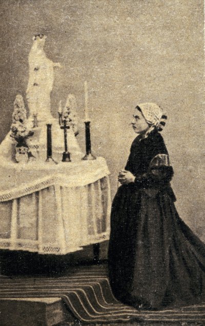 Bernadette Soubirous inginocchiata davanti a un altare con la Vergine da Unknown photographer