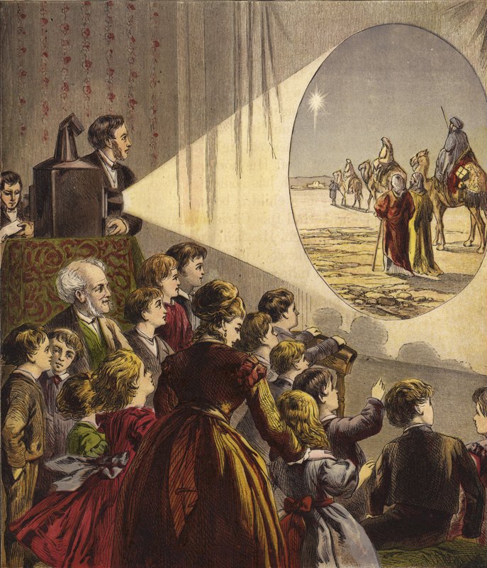 Bambini che guardano uno spettacolo di lanterna magica sulla storia di Natale da English School
