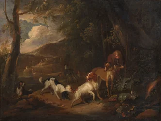 Cacciatore con cani ai margini di un bosco