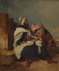 Uomo arabo seduto con cavallo