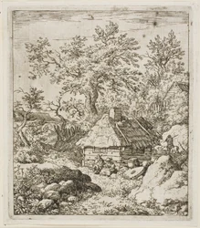 Capanna con tetto di paglia tra alberi e rocce