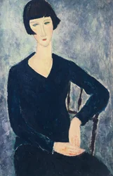 Giovane donna con frangia o giovane donna seduta in abito blu