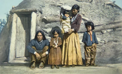 Cartolina di una famiglia di indiani Navajo fuori dalla loro casa o 