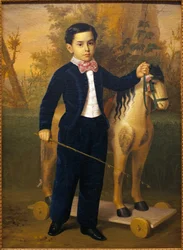 Ritratto di un bambino con un cavallo di legno