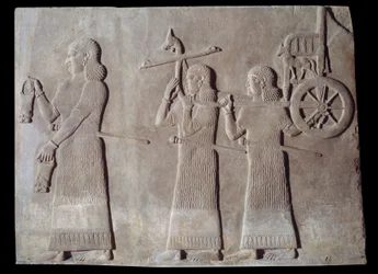 Arte mesopotamica (Assiria): corte del palazzo del re di Assiria Sargon II (721 - 705 a.C.) servitori che portano le situle e il carro del re. Parigi, Museo del Louvre