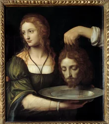 Salomè riceve la testa di san Giovanni Battista. A Salomè viene offerta su un vassoio la testa decapitata di san Giovanni Battista, che ella aveva richiesto durante il banchetto di Erode Antipa ed Erodiade. Dipinto di Bernardino de Scapis, noto come