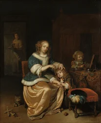Interno con una madre che pettina i capelli del suo bambino, noto come 