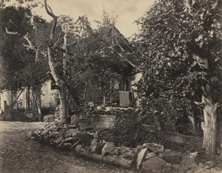 Scena rurale con edificio in pietra e croce